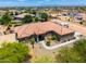 Close aerial view of a desert house highlighting the entryway, xeriscaping, and manicured trees at 3614 W Phillips Rd, San Tan Valley, AZ 85144