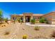 Desert-style landscaping with decorative rock and native plants frames this home's entry at 3614 W Phillips Rd, San Tan Valley, AZ 85144