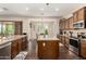 Bright kitchen featuring wood cabinets, stainless steel appliances, and an island with a breakfast bar at 3614 W Phillips Rd, San Tan Valley, AZ 85144