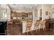 Open kitchen featuring wood cabinets, granite countertops, and a center island with bar seating at 3614 W Phillips Rd, San Tan Valley, AZ 85144