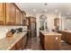 Well-equipped kitchen with stainless steel appliances, wood cabinetry, and granite countertops at 3614 W Phillips Rd, San Tan Valley, AZ 85144
