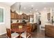 Eat in kitchen with wooden table and chairs, wooden cabinets, granite countertops, and an island at 3614 W Phillips Rd, San Tan Valley, AZ 85144