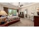 Comfortable bedroom with carpet floors, a ceiling fan, a TV and sliding glass doors that open to the back yard at 3614 W Phillips Rd, San Tan Valley, AZ 85144