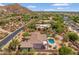 Home with a backyard pool nestled amongst desert landscaping in a scenic community near a hillside at 3946 N Pinnacle Hills Cir, Mesa, AZ 85207