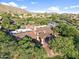 Aerial view of estate with distinctive roof and verdant, mature landscaping at 3946 N Pinnacle Hills Cir, Mesa, AZ 85207
