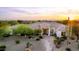 Stunning aerial view of a desert home with lush landscaping, desert plants, and mountain views at 3946 N Pinnacle Hills Cir, Mesa, AZ 85207