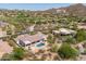 Aerial view of a desert home featuring a pool and set in a golf community with mountain views at 3946 N Pinnacle Hills Cir, Mesa, AZ 85207