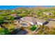 An aerial view of a luxury home nestled in a desert landscape, featuring a pool, spa, covered patio, and mountain views at 3946 N Pinnacle Hills Cir, Mesa, AZ 85207