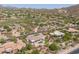 Aerial shot of desert home in golf community featuring a pool and lush desert landscaping at 3946 N Pinnacle Hills Cir, Mesa, AZ 85207