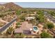 Aerial view of a luxury home featuring a private pool, outdoor spiral staircase, and desert landscaping at 3946 N Pinnacle Hills Cir, Mesa, AZ 85207
