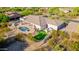An aerial view of a luxury home featuring a pool, spa, covered patio, built in bbq, desert landscaping, and mountain views at 3946 N Pinnacle Hills Cir, Mesa, AZ 85207