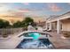 A backyard oasis awaits with a sparkling pool, spa, outdoor kitchen, fireplace, and multiple seating areas for entertaining at 3946 N Pinnacle Hills Cir, Mesa, AZ 85207