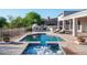 A backyard oasis awaits with a sparkling pool, spa, outdoor kitchen, fireplace, and multiple seating areas for entertaining at 3946 N Pinnacle Hills Cir, Mesa, AZ 85207