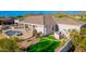 Aerial view of backyard featuring a pool, patio, synthetic grass area, and mountain views at 3946 N Pinnacle Hills Cir, Mesa, AZ 85207