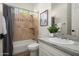 Cozy bathroom featuring travertine tile, a shower with bathtub, and a modern vanity at 3946 N Pinnacle Hills Cir, Mesa, AZ 85207