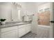 Elegant bathroom with a patterned floor, marble countertop, and a bathtub with tiled enclosure at 3946 N Pinnacle Hills Cir, Mesa, AZ 85207