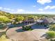 Aerial view of clubhouse entrance with manicured landscaping and US flag in a circular driveway at 3946 N Pinnacle Hills Cir, Mesa, AZ 85207
