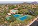 Aerial view of the community pool, tennis courts, and clubhouse area at 3946 N Pinnacle Hills Cir, Mesa, AZ 85207