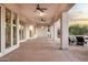 Expansive covered patio featuring multiple ceiling fans, stone pillars, and outdoor seating at 3946 N Pinnacle Hills Cir, Mesa, AZ 85207