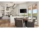 Dining area with a wood table, four chairs, and sliding glass doors to the outdoor pool area at 3946 N Pinnacle Hills Cir, Mesa, AZ 85207