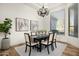Elegant dining room with a modern chandelier, and large window with natural light at 3946 N Pinnacle Hills Cir, Mesa, AZ 85207