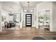Open entryway with a tray ceiling, chandelier, front door, dining room and an office at 3946 N Pinnacle Hills Cir, Mesa, AZ 85207