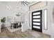 Elegant entryway featuring a modern front door, wood-look tile floors, and a view of the formal dining area at 3946 N Pinnacle Hills Cir, Mesa, AZ 85207