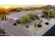 Home exterior features a three-car garage and desert landscaping providing a serene and private setting at 3946 N Pinnacle Hills Cir, Mesa, AZ 85207