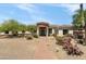 Charming home showcasing a unique stone turret entrance, xeriscaping, and a modern black front door at 3946 N Pinnacle Hills Cir, Mesa, AZ 85207
