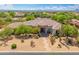 Charming desert home with mature trees, landscaping, a stone walkway, and a prominent portico at 3946 N Pinnacle Hills Cir, Mesa, AZ 85207