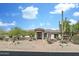 Inviting front exterior featuring desert landscaping and covered entryway at 3946 N Pinnacle Hills Cir, Mesa, AZ 85207