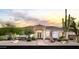 Home exterior features desert landscaping and a covered entry with landscape lighting providing a serene and inviting ambiance at 3946 N Pinnacle Hills Cir, Mesa, AZ 85207