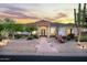 Elegant home exterior featuring desert landscaping, a stone accent, and a covered entry, illuminated by landscape lighting at 3946 N Pinnacle Hills Cir, Mesa, AZ 85207