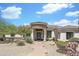 Elegant home featuring desert landscaping, a circular stone entrance, and a grand front door at 3946 N Pinnacle Hills Cir, Mesa, AZ 85207