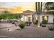 Inviting desert landscaped front yard featuring a modern home with stone accents and a circular entryway at 3946 N Pinnacle Hills Cir, Mesa, AZ 85207