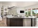 Open-concept kitchen island with stainless steel dishwasher, dark cabinets, and marble countertops at 3946 N Pinnacle Hills Cir, Mesa, AZ 85207