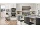 Close up of kitchen island with barstool seating, stainless steel appliances and custom cabinetry at 3946 N Pinnacle Hills Cir, Mesa, AZ 85207