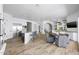 Open-concept kitchen and dining area with a large island, stainless steel appliances, and wood-look flooring at 3946 N Pinnacle Hills Cir, Mesa, AZ 85207