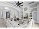 Inviting living room showcasing custom built-in shelving, a modern ceiling fan, and an open floor plan at 3946 N Pinnacle Hills Cir, Mesa, AZ 85207