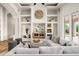 Spacious living room featuring built-in shelves, modern decor, and a comfortable white sofa at 3946 N Pinnacle Hills Cir, Mesa, AZ 85207