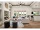 Bright living room featuring a ceiling fan, white sofa, neutral decor, and an open floorplan at 3946 N Pinnacle Hills Cir, Mesa, AZ 85207