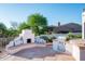 Inviting outdoor kitchen and seating area with built-in BBQ and desert views at 3946 N Pinnacle Hills Cir, Mesa, AZ 85207