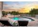 Relaxing pool area featuring lounge chairs and serene views, perfect for enjoying sunset moments at 3946 N Pinnacle Hills Cir, Mesa, AZ 85207