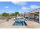 Backyard featuring a pool, spa, outdoor kitchen, fireplace, and scenic desert views, perfect for outdoor entertaining at 3946 N Pinnacle Hills Cir, Mesa, AZ 85207
