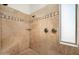 Walk in shower featuring a travertine tile surround, tiled bench, and brushed bronze fixtures at 3946 N Pinnacle Hills Cir, Mesa, AZ 85207