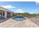 Swimming pool with waterfall feature, surrounded by a stone patio and desert landscaping at 3946 N Pinnacle Hills Cir, Mesa, AZ 85207