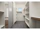 Spacious walk-in closet with built-in shelving and grey carpet, providing ample storage space at 3946 N Pinnacle Hills Cir, Mesa, AZ 85207