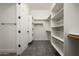 Walk-in closet with custom shelving and carpet at 3946 N Pinnacle Hills Cir, Mesa, AZ 85207