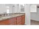 Bathroom featuring dual sinks, vanity and view of closet at 3977 E Cat Balue Dr, Phoenix, AZ 85050