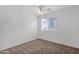 Spacious bedroom with carpet floors, ceiling fan and large window at 3977 E Cat Balue Dr, Phoenix, AZ 85050